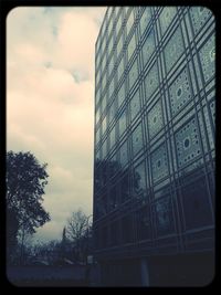 Low angle view of building against cloudy sky