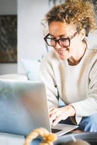 Young woman using laptop at home