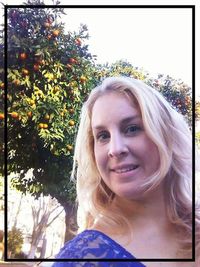 Portrait of smiling woman against plants