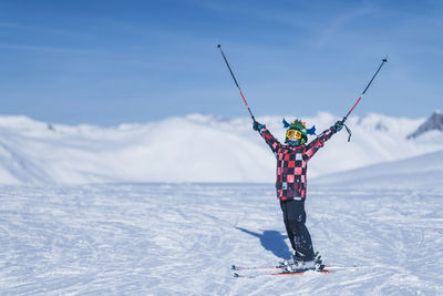 Boy skiing on snowcapped mountain