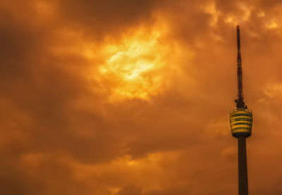 Low angle view of communications tower against sky during sunset