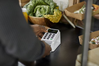 Close-up of person using card reader