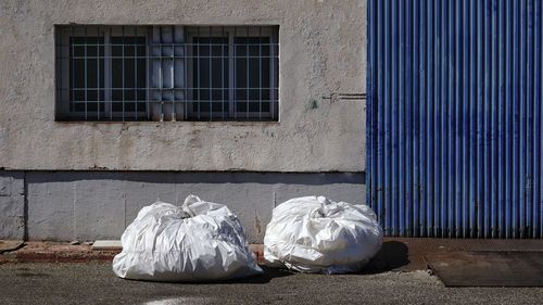 Garbage on street against building