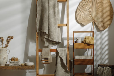 Linen hanging on ladder against wall