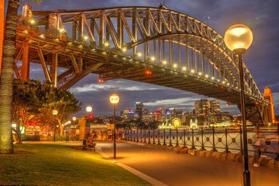 Illuminated bridge against sky at night