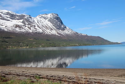 Scenic view of lake and mountains against sky