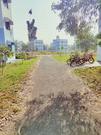 Surface level of bicycle by road against sky