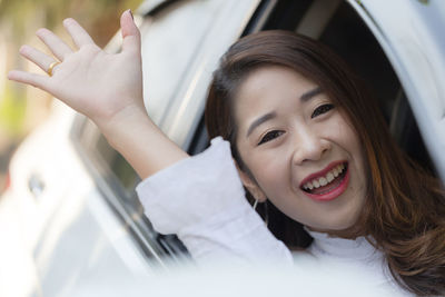 Portrait of a smiling young woman in car