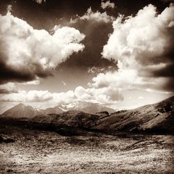 Scenic view of mountains against cloudy sky