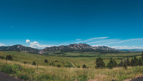 Scenic view of landscape against blue sky