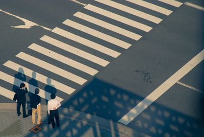 High angle view of people walking on road