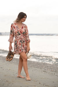 Young woman standing at beach