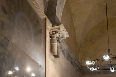 Low angle view of illuminated pendant lights hanging in building