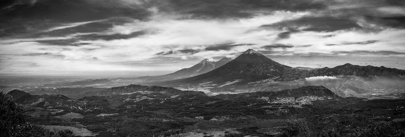 Scenic view of snowcapped mountains against cloudy sky