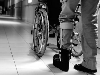 Low section of people walking on tiled floor