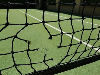 Low angle view of broken net on tennis court