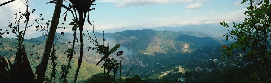 Scenic view of mountains against cloudy sky