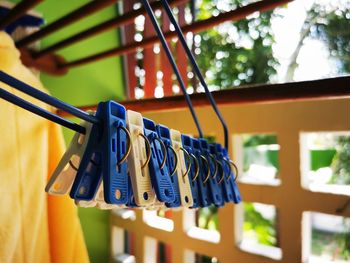 Close-up of clothespins hanging on rope