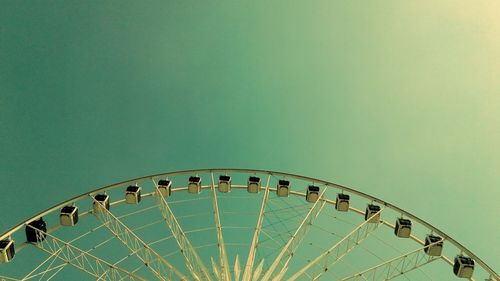 Low angle view of ferris wheel against clear sky