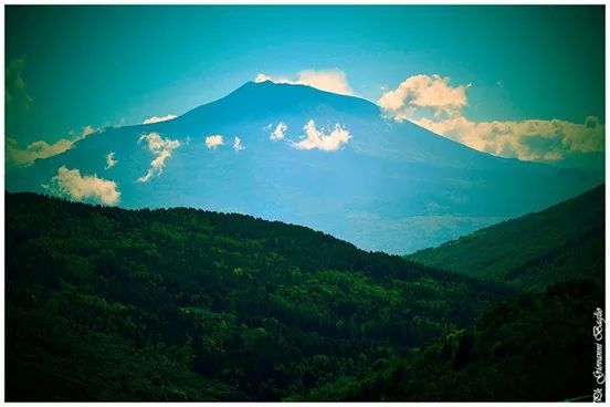 mountain, mountain range, tranquil scene, scenics, tranquility, landscape, beauty in nature, nature, transfer print, sky, blue, non-urban scene, idyllic, auto post production filter, tree, physical geography, valley, remote, majestic, geology