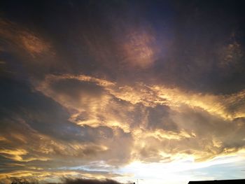 Low angle view of dramatic sky during sunset