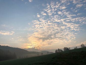 Scenic view of field against sky during sunset