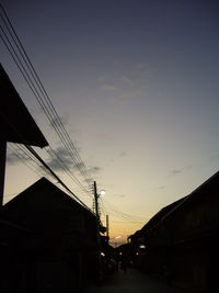 Low angle view of electricity pylon against sky