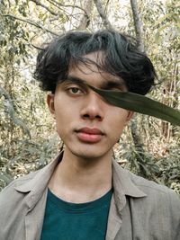 Portrait of young man against plants