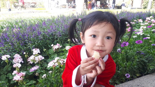 Portrait of cute girl with purple flowers