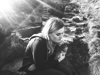 Portrait of young woman sitting outdoors