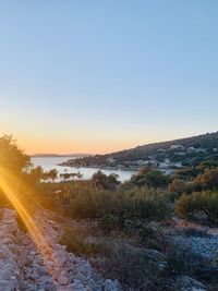 Scenic view of landscape against clear sky during sunset