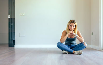 Portrait of young woman sitting at home