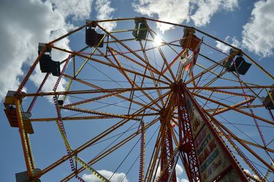 Low angle view of ferris wheel against sky