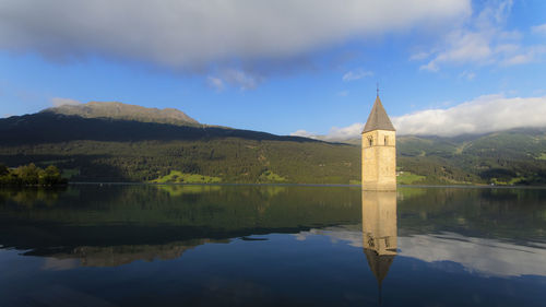 Scenic view of lake by building against sky