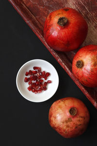 Close-up of red fruit against black background