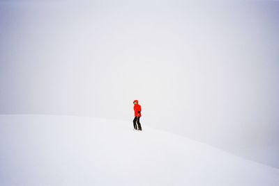 Person with umbrella on snow during winter