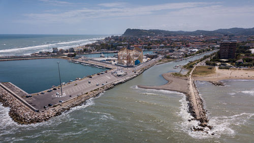 High angle view of sea and cityscape against sky