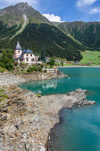 Scenic view of lake by buildings against sky