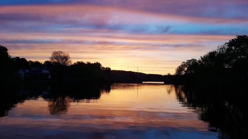 Scenic view of lake against sky during sunset