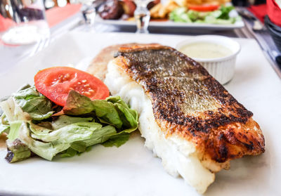 Grilled fish steak with salad