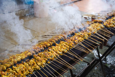 High angle view of meat on barbecue grill