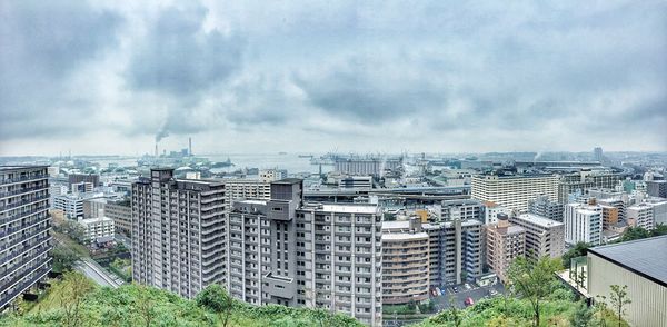 Cityscape against cloudy sky