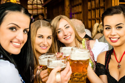 Portrait of happy women enjoying beer at oktoberfest