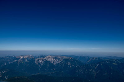 Scenic view of snowcapped mountains against clear blue sky