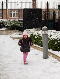 Full length of girl standing in snow