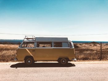 Vintage car on road against clear sky
