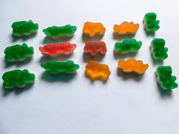 High angle view of multi colored candies against white background
