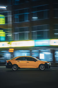 Cars on city street at night