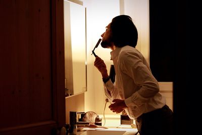 Man shaving mustache at home