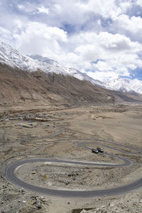 Winding curvy rural road with light trail from headlights leading through ladakh in india.